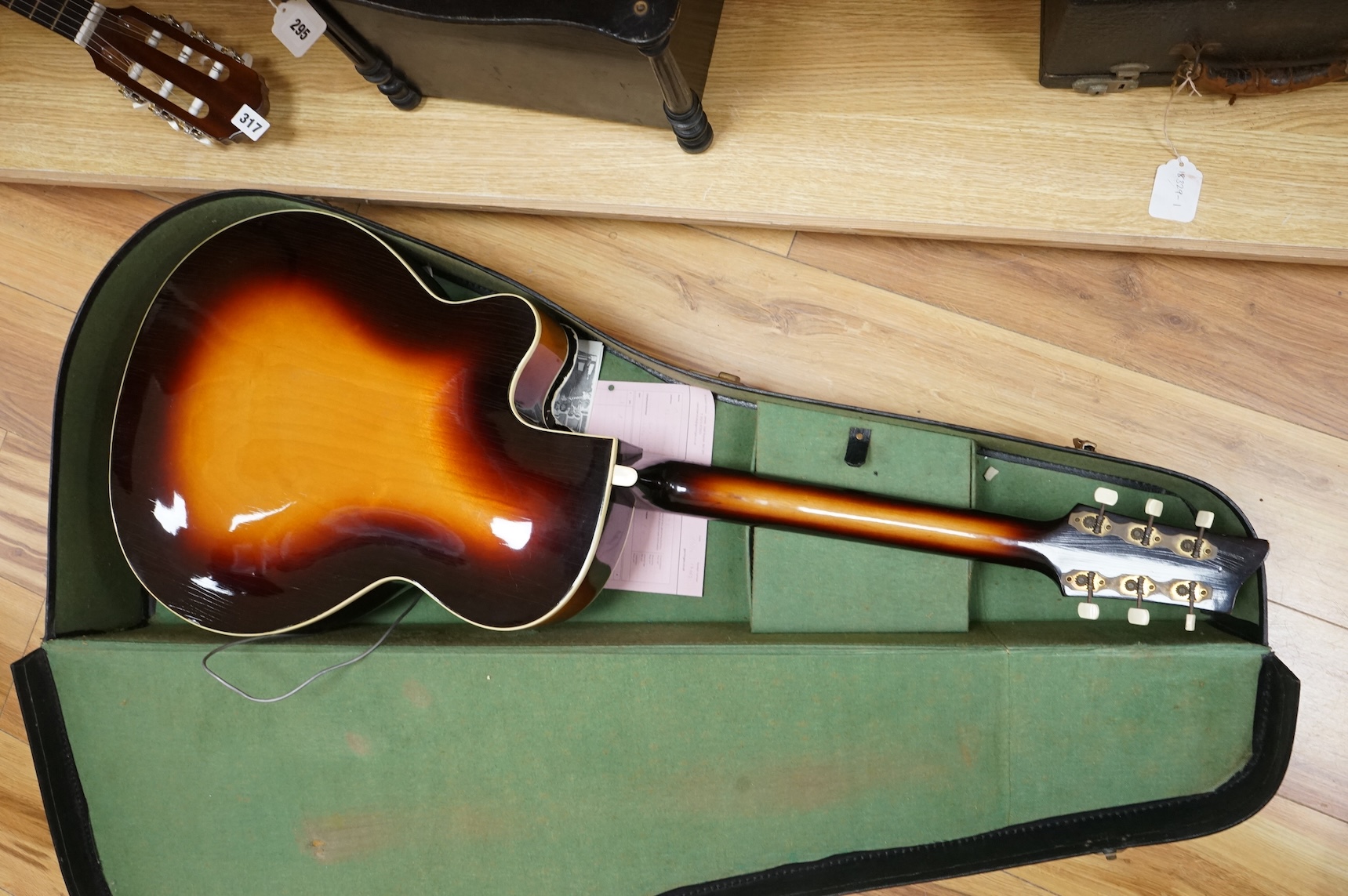 A 1950's Hofner style cut-away acoustic guitar, fitted with a pick up bearing Hofner engraved signature, with hard case.